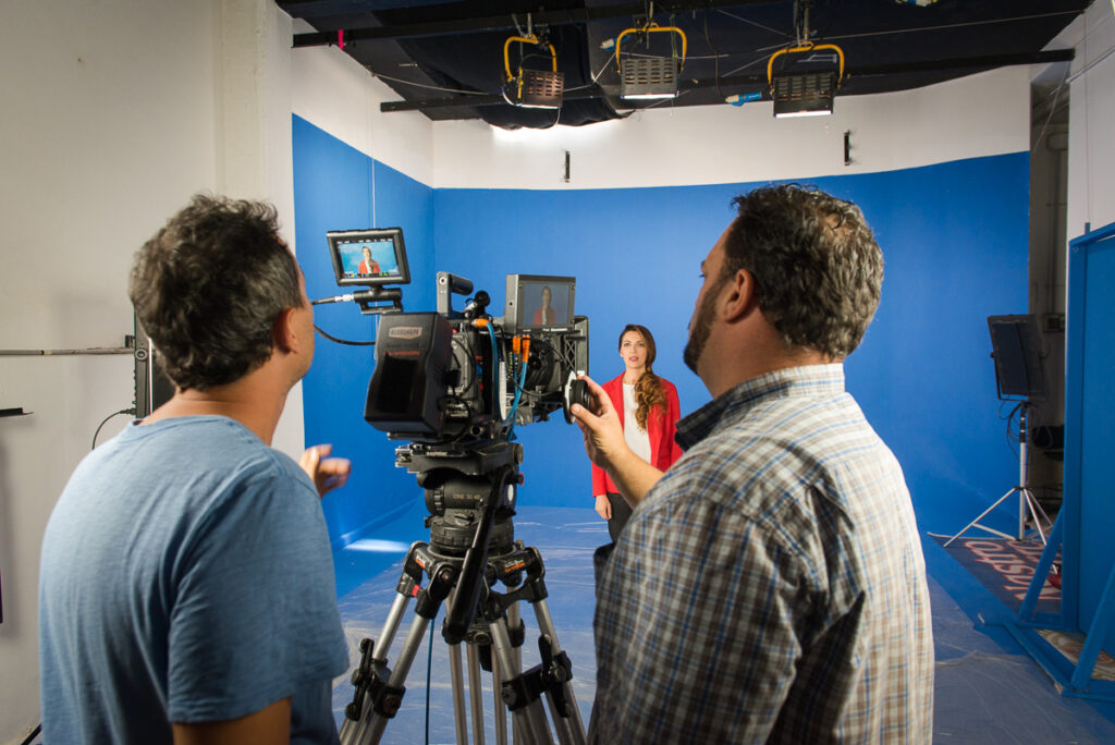 Instudio.org: Model in Red Jacket Shot on Studio C Blue Screen with Camera Operator and focus puller