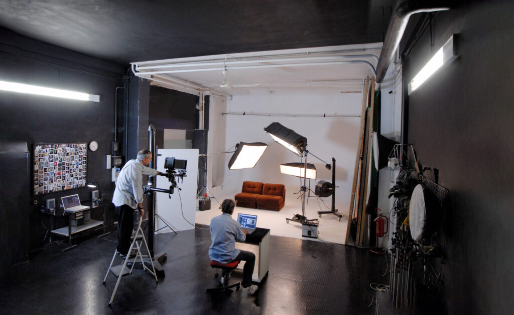 A team of professionals hard at work in Studio A in action during a photoshoot of large-scale furniture.